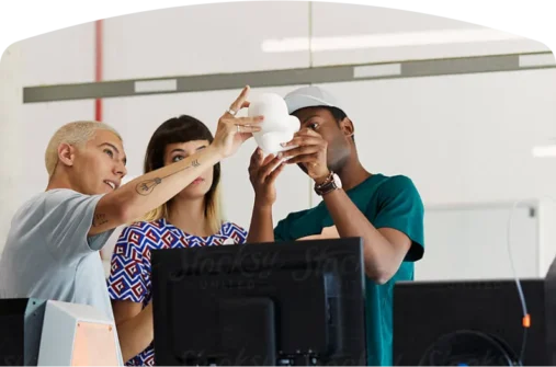 3 student examining a small white object