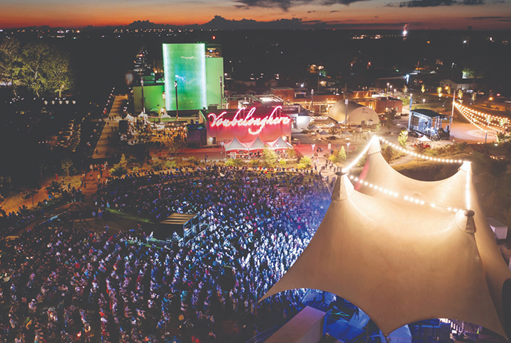 Aerial view of the Momentary museum and event space at night with a concert in progress